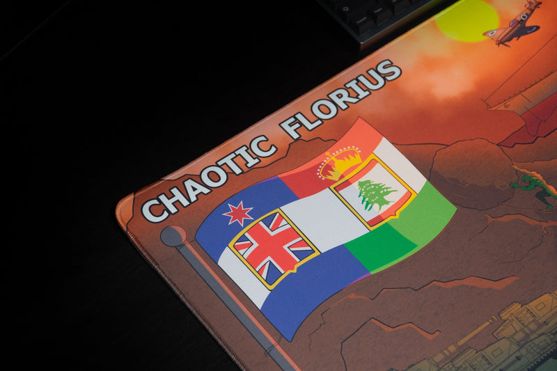 Close-up of the colorful flag and Chaotic Florius lettering on the Chaotic Dawn deskmat.