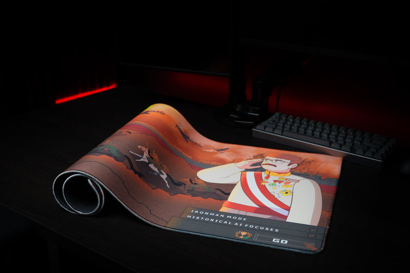 Florius Chaotic Dawn deskmat partially rolled on a dark desk, with cavalry and cartoon commander artwork visible.