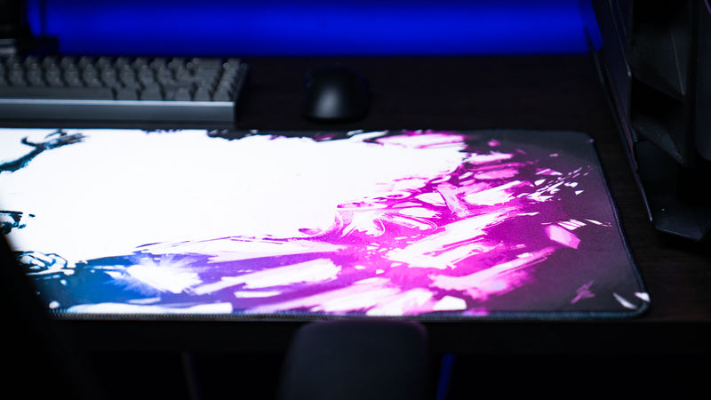 Detailed view of the Forbidden Spoils premium XXL gaming deskmat highlighting the vibrant purple crystal artwork and smooth cloth mouse surface.