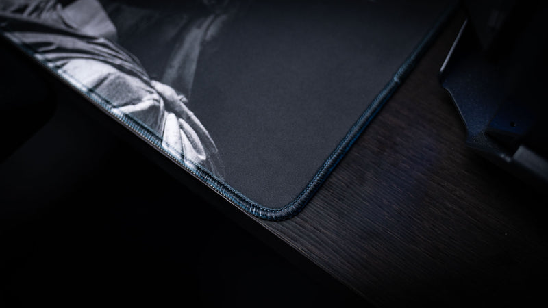 Close-up of the Freedom deskmat corner highlighting premium stitched edges, smooth cloth surface, monochrome Statue of Liberty artwork, and durable extended gaming mouse pad craftsmanship.