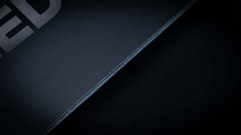 Close-up of the Freedom deskmat showcasing premium stitched edges, smooth cloth gaming surface, precision craftsmanship, and durable extended mouse pad construction.