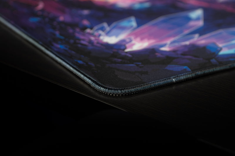 Keyboard close-up on GHOSTYMPA's Perplexray's Paradise deskmat, with colorful crystals, eye motifs and white light beams.