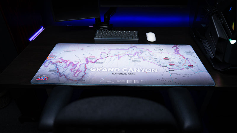 Grand Canyon Purple deskmat featuring a detailed purple topographic map of Grand Canyon National Park displayed across a modern gaming desk with a mechanical keyboard and mouse.