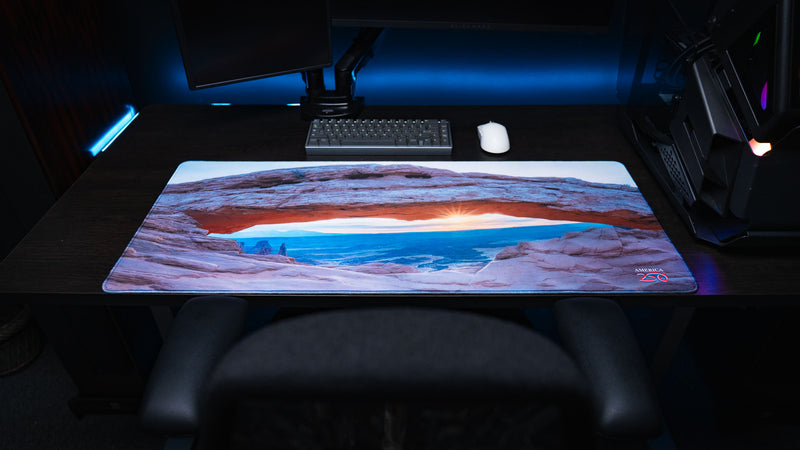Front view of the Grand Mesa Sunrise deskmat featuring Mesa Arch at sunrise in Canyonlands National Park with vivid HD photography, premium stitched edges, and an extended gaming surface.