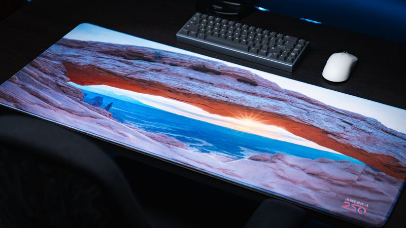 Grand Mesa Sunrise deskmat featuring Mesa Arch at sunrise in Canyonlands National Park with vibrant HD photography, premium stitched edges, and a smooth gaming surface.