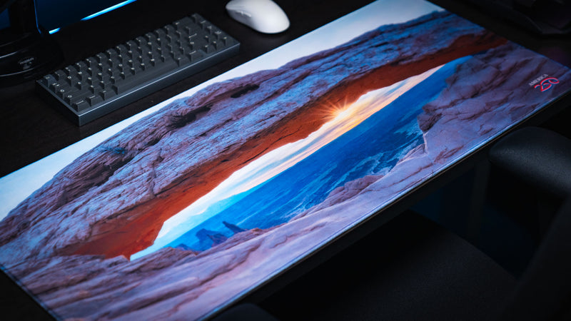 Grand Mesa Sunrise deskmat featuring Mesa Arch at sunrise in Canyonlands National Park with vibrant HD photography, premium stitched edges, and a panoramic gaming surface.