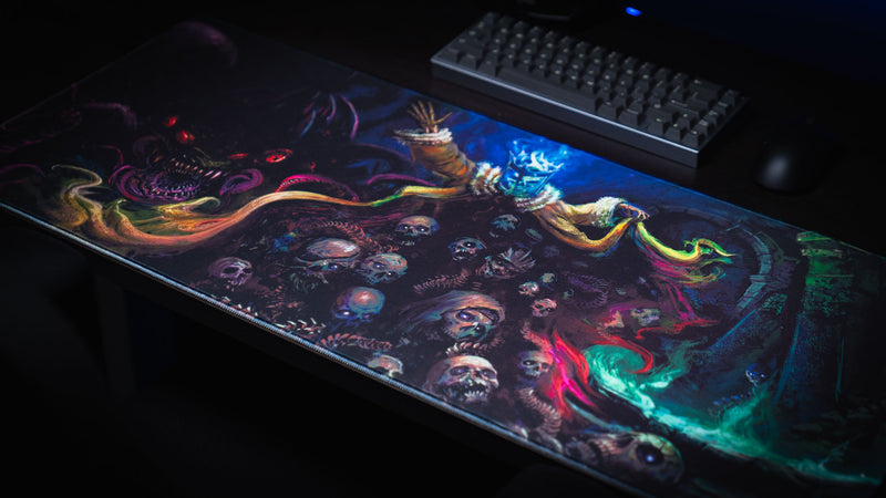 Angled view of the Grim Kleeper Dominion of the Dark desk mat beneath a compact keyboard