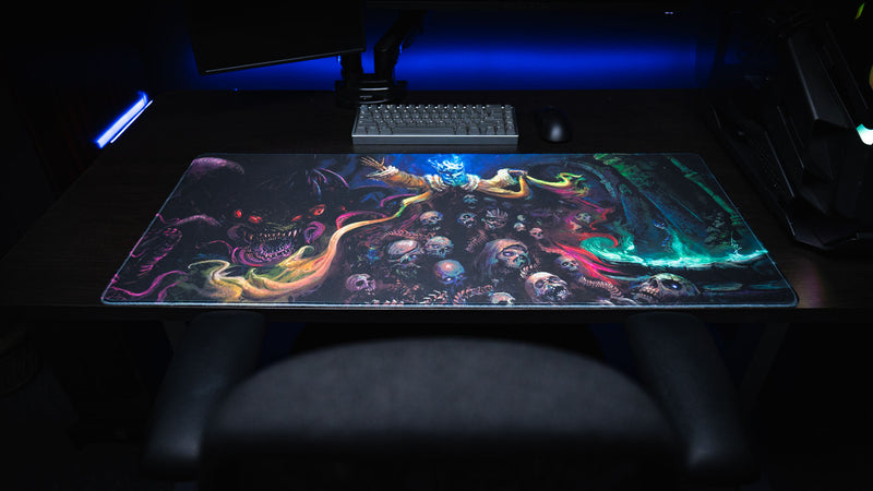 Centered desk setup showing the Grim Kleeper Dominion of the Dark desk mat beneath a keyboard