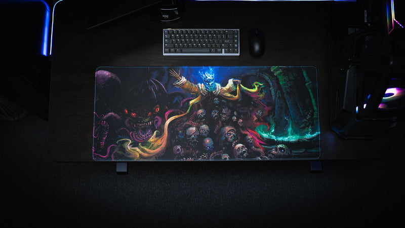 Overhead desk setup featuring the Grim Kleeper Dominion of the Dark gaming desk mat beneath a keyboard