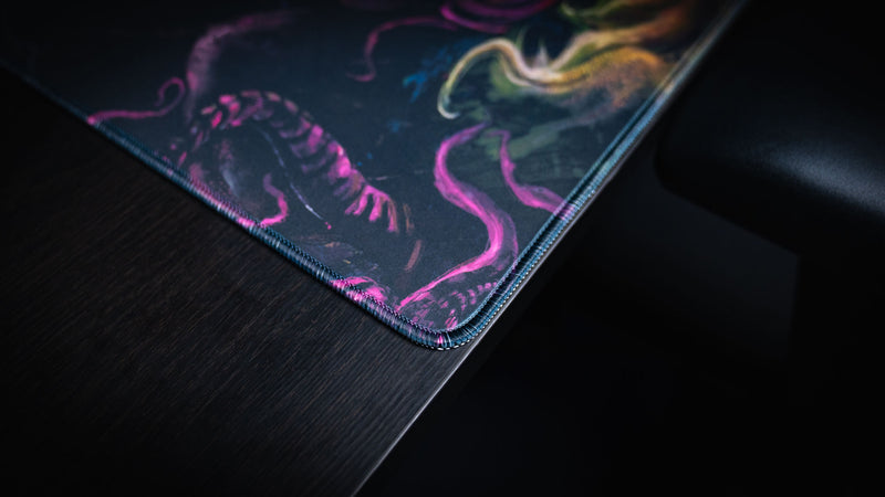 Close view of the stitched corner and printed edge on the Dominion of the Dark desk mat