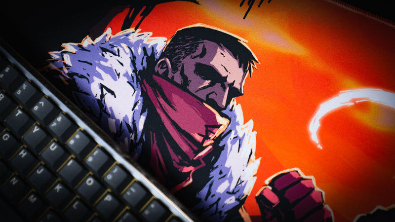 Close view of the scarfed warrior artwork beside a keyboard on the Redemption on the Old Road desk mat
