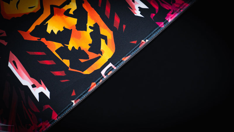 Close detail of the crusader chest emblem and stitched edge on the Grim Kleeper Spare Them desk mat