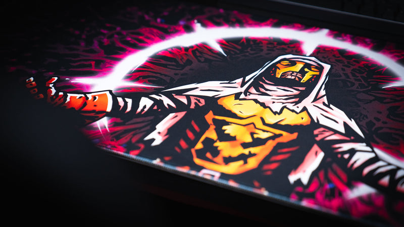 Close angled view of the hooded crusader artwork on the Grim Kleeper Spare Them desk mat