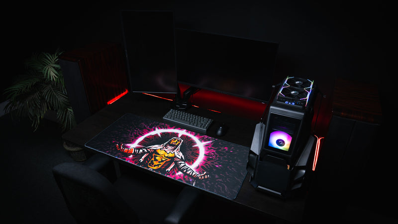 Dark gaming setup featuring the Grim Kleeper Spare Them desk mat with red accent lighting