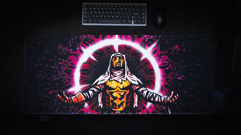 Overhead full view of the Grim Kleeper Spare Them gaming desk mat beneath a keyboard