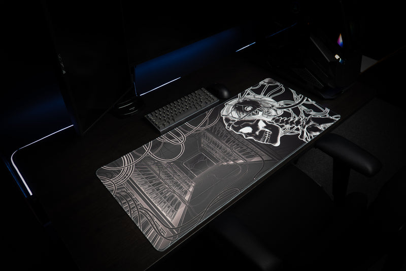 Angled gaming setup with GRRT Another Nerf deskmat, keyboard, and monochrome skull artwork