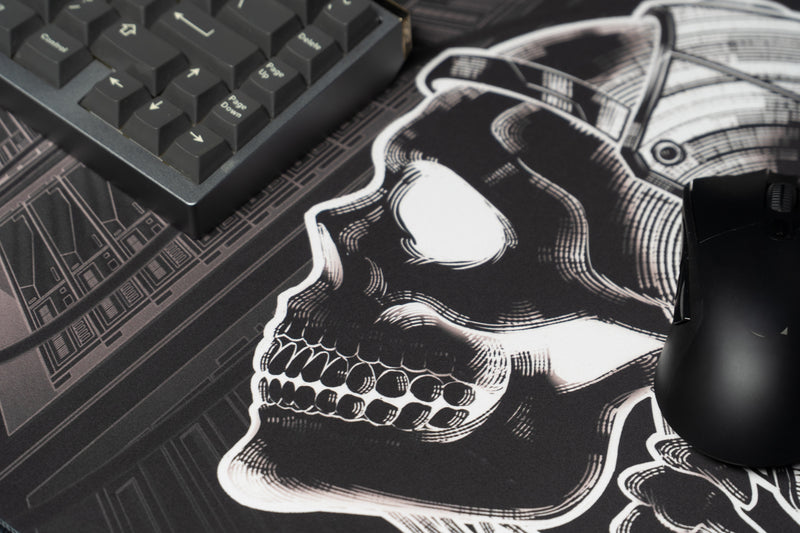 GRRT Another Nerf deskmat skull artwork shown beside a keyboard and gaming mouse