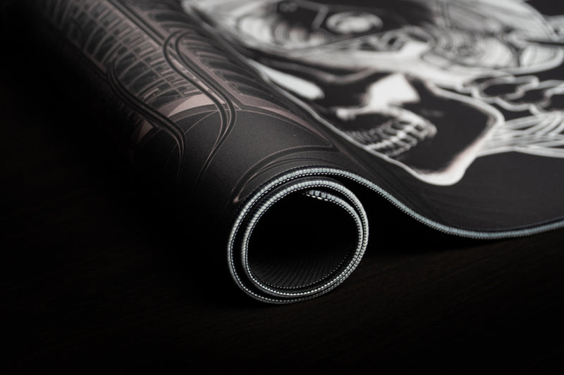Rolled GRRT Another Nerf deskmat showing stitched edge and textured rubber backing