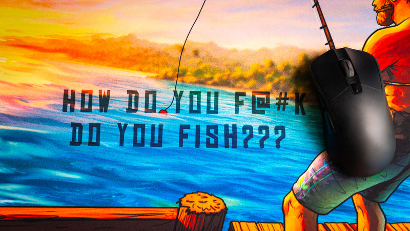 Close-up of the iconic "How Do You F@#K Do You Fish???" quote on Posty's deskmat, featuring vibrant sunset colors, ocean reflections, fishing lure detail, and premium print quality.