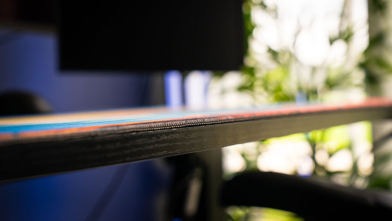 Macro side profile of the How Do You F@#K Do You Fish deskmat by Posty showcasing premium stitched edges, low-profile construction, and detailed craftsmanship.