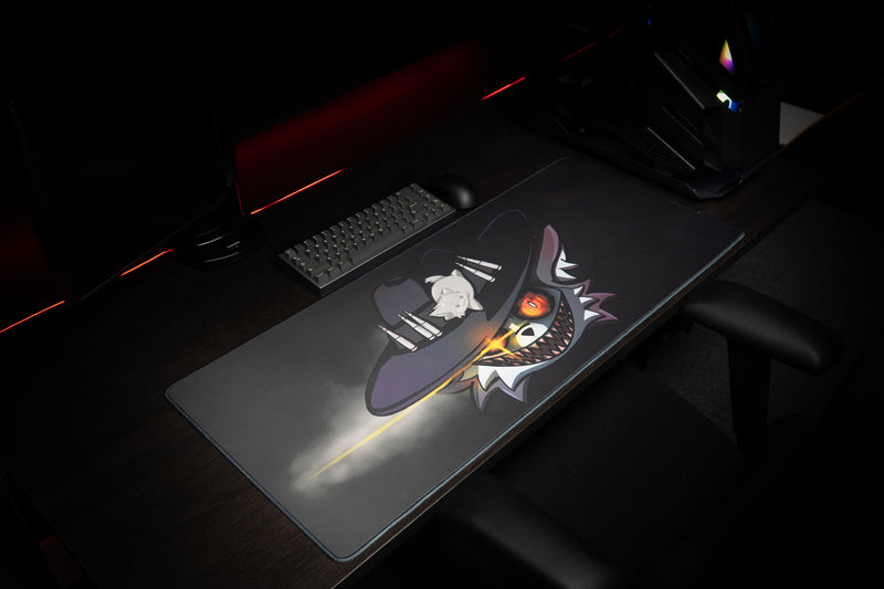 Angled view of Iddqd's Chonk Mat deskmat with smoky black artwork and a fiery-eyed cowboy cat below a keyboard.
