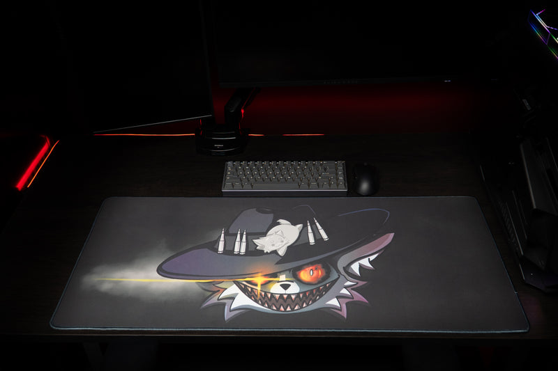 Top view of Iddqd's Chonk Mat deskmat showing the full cowboy cat artwork beneath a keyboard and mouse.