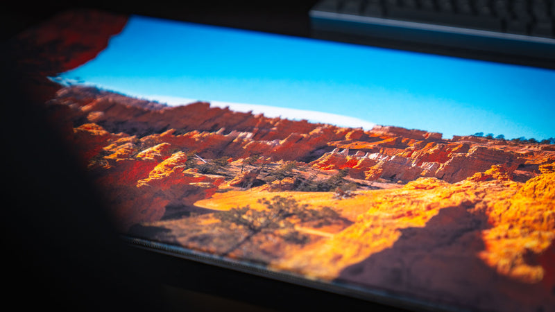 Close-up detail of the In the Hoodoos Bryce Canyon National Park deskmat highlighting vibrant hoodoo formations, rich print quality, smooth fabric surface, and stitched edges.