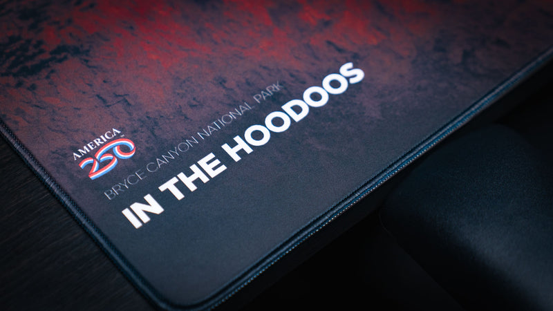 Close-up of the In the Hoodoos Bryce Canyon National Park deskmat featuring the America 250 logo, premium printed artwork, and finely stitched edges.