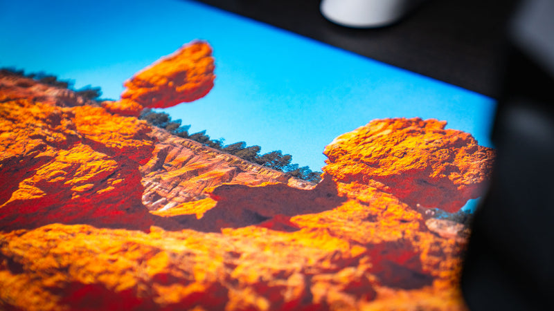 Macro close-up of the In the Hoodoos Bryce Canyon National Park deskmat highlighting vivid hoodoo rock formations, crisp print quality, and the smooth premium fabric surface.