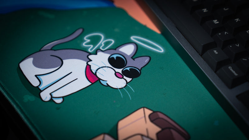 Close-up of the angel cat artwork on ItzOutlaw's Glorious Victory gaming desk mat