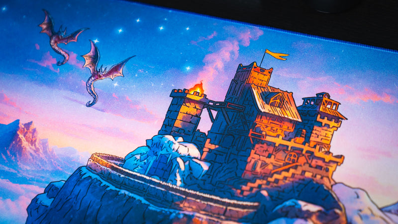 Close-up of dragons circling the snowy cliffside fortress in the Jakk Frost Hold desk mat artwork