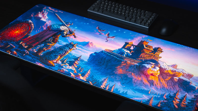 Angled overhead view of the full Jakk Frost Hold desk mat with warrior, dragons, and icy fortress