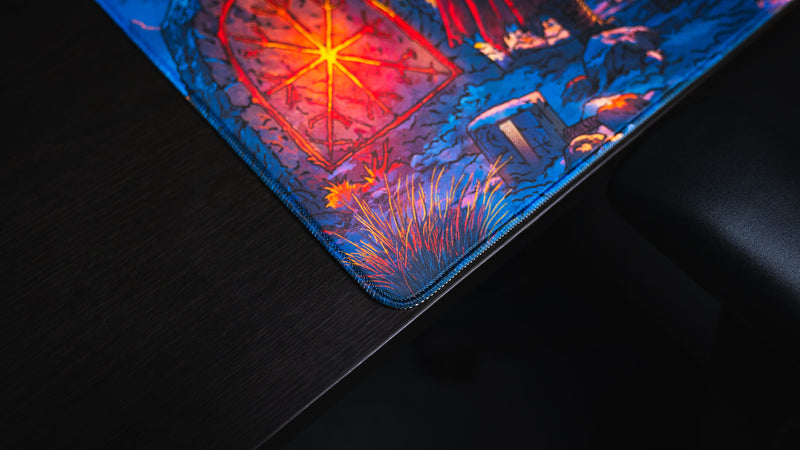 Rounded stitched corner with the glowing red rune gate artwork on the Jakk Frost Hold desk mat