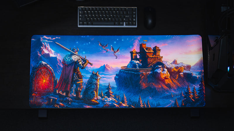 Overhead desk setup with keyboard and mouse above the colorful Jakk Frost Hold gaming desk mat