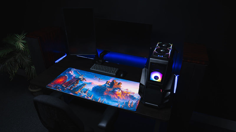 Wide RGB gaming setup featuring the vivid blue Jakk Frost Hold desk mat and desktop PC