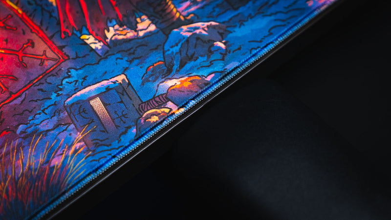Close-up of the stitched edge and snowy landscape detail on the Jakk Frost Hold desk mat
