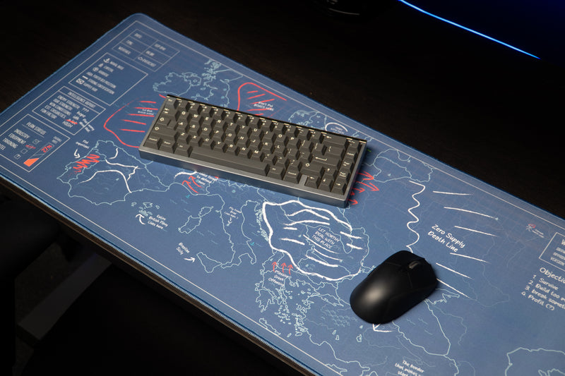 Keyboard and mouse on the Jaush deskmat, showing its blue European map, white borders, and red tactical markings.