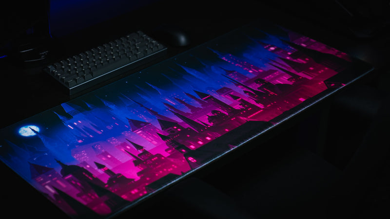 Diagonal desktop view of the Chroma Kingdom gaming deskmat and keyboard
