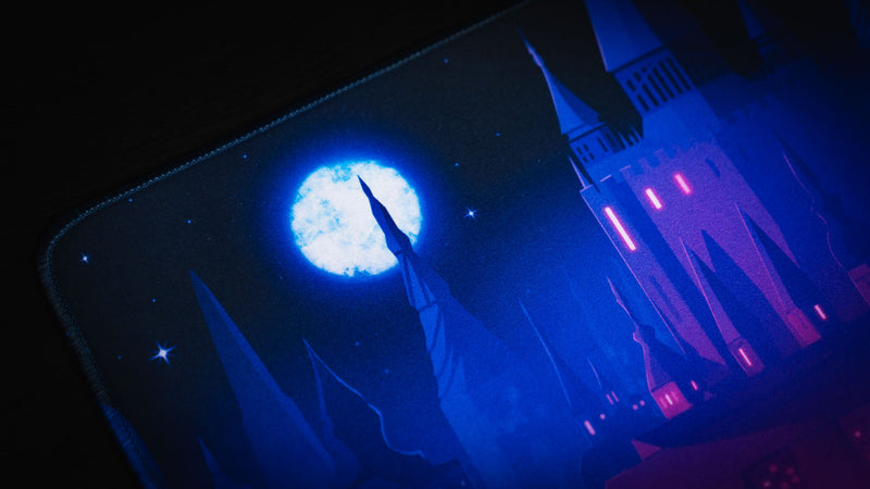 Moonlit castle and blue spire detail on the Chroma Kingdom deskmat