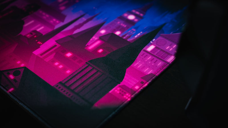Close-up of neon magenta castle artwork on the Chroma Kingdom deskmat