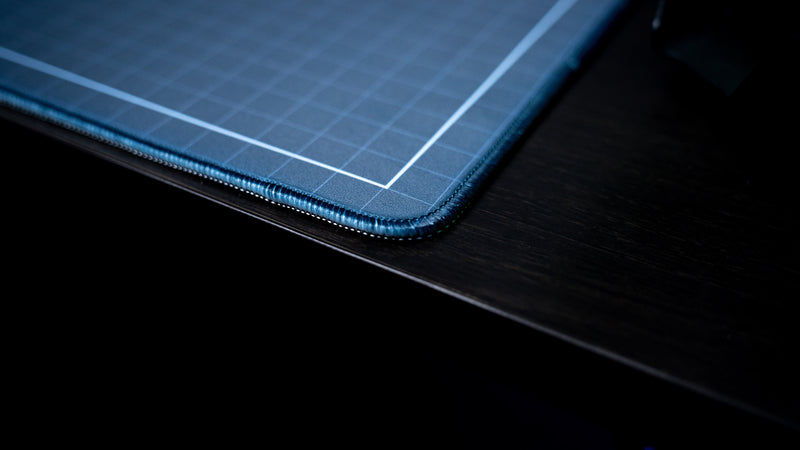 Close-up of the stitched edge and premium fabric surface on the Jimarkus F35 Schematic deskmat featuring a blueprint-inspired aviation design.