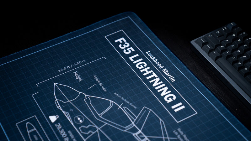 Close-up of the Jimarkus F35 Schematic deskmat featuring the Lockheed Martin F-35 Lightning II blueprint title, technical aircraft diagram, and premium stitched edge.
