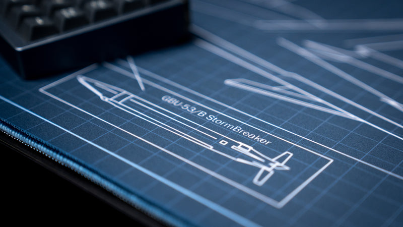 Close-up of the GBU-53/B StormBreaker blueprint on the Jimarkus F35 Schematic deskmat, showcasing detailed aircraft weapon schematics and premium stitched edges.