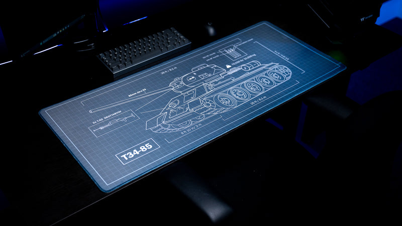 Angled view of the Jimarkus T-34 Schematic deskmat featuring a detailed T-34-85 tank blueprint with technical measurements across the full desk surface.