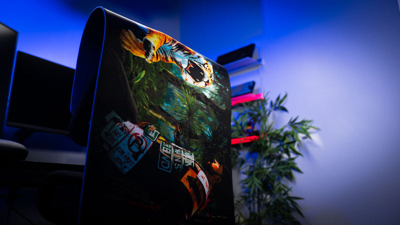 Official Rust Jungle Ambush deskmat displayed flexed upright, highlighting the vibrant artwork, stitched edges, and flexible construction.