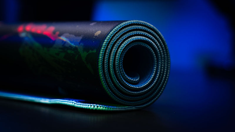 Rolled official Rust Jungle Ambush deskmat showcasing stitched edges, premium thickness, and durable construction.