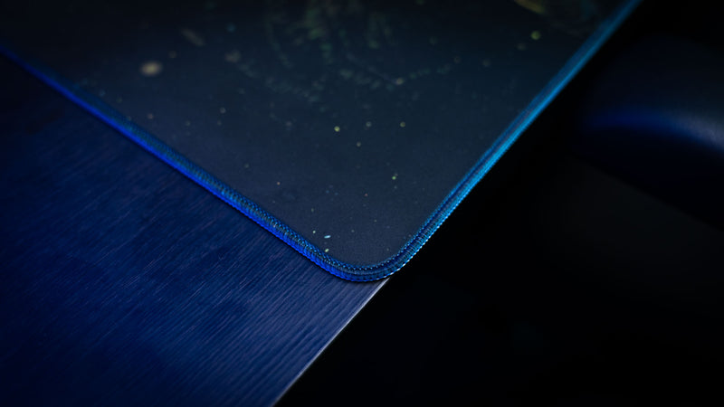 Close-up of the stitched edge and premium surface of the official Rust Jungle Ambush deskmat.