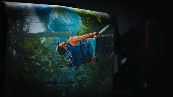 Rolled deskmat edge-on, showing the stitched border and the cushioned 4 mm core
