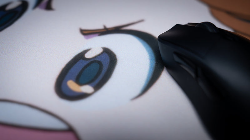 Close-up of the Kill la Kill “Mako’s Fury” anime deskmat featuring detailed character artwork and a gaming mouse on the smooth fabric surface.