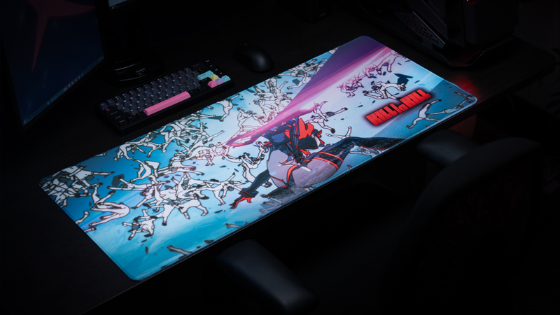 Anime battlestation setup featuring the Kill la Kill “Ryuko’s Rampage” deskmat with explosive action artwork, keyboard, and gaming mouse.